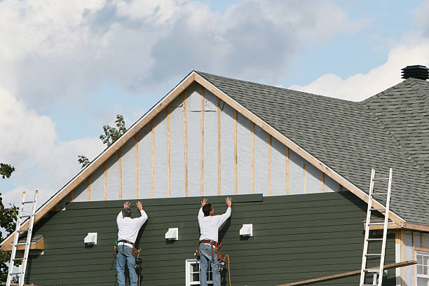 Professional Storm Damage Siding Repair technician working in New Philadelphia, OH